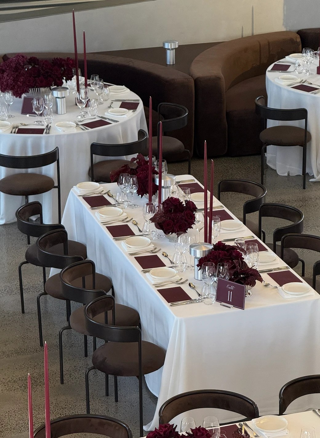 Long banquet table styled in burgundy