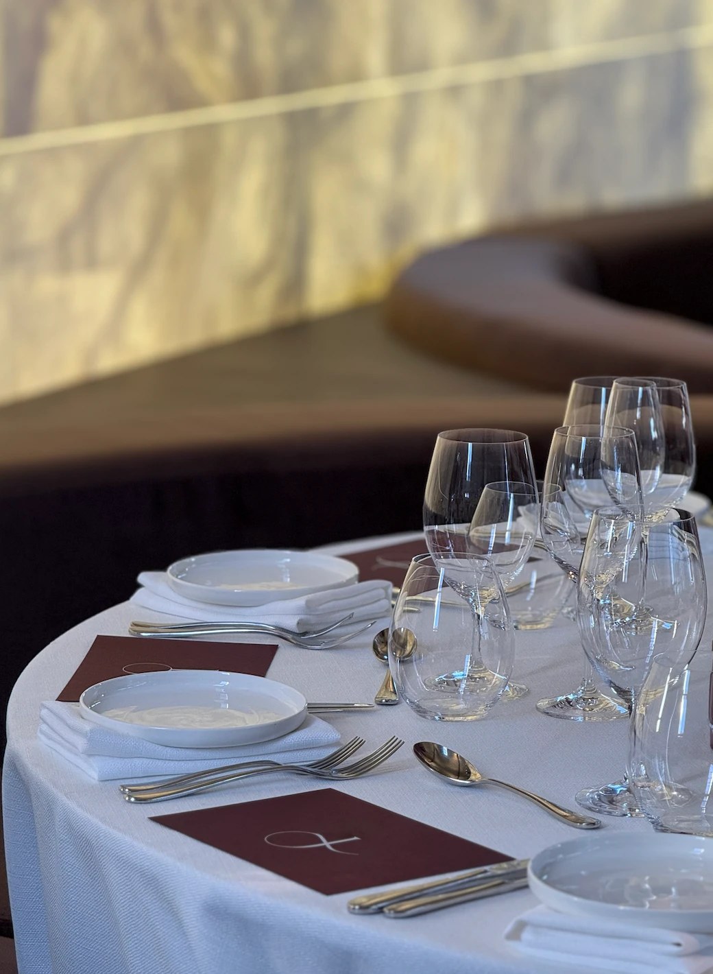 Round table setting in burgundy and white