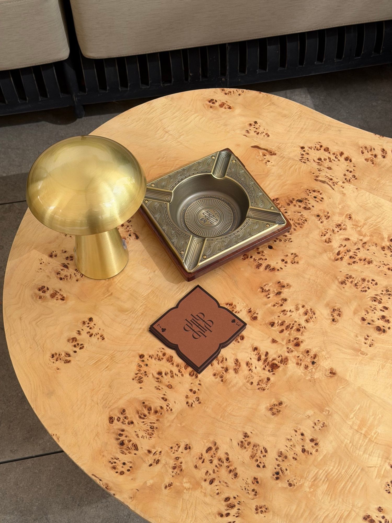 Ashtray and lamp on burl table
