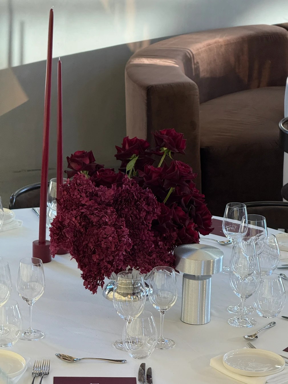 Place setting with burgundy taper candles